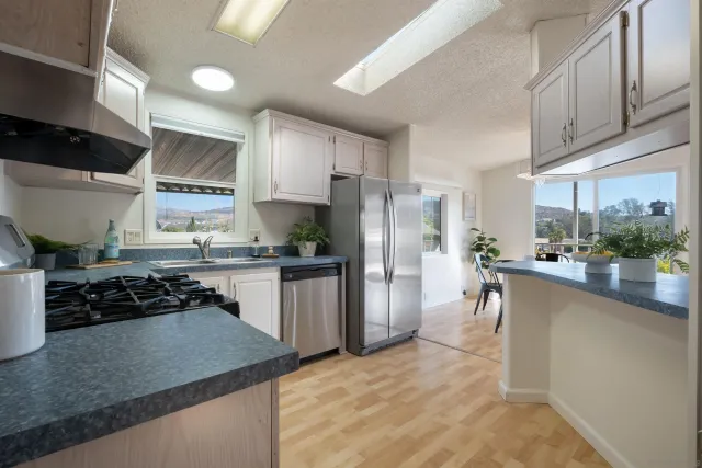 a kitchen with refrigerator and cabinets
