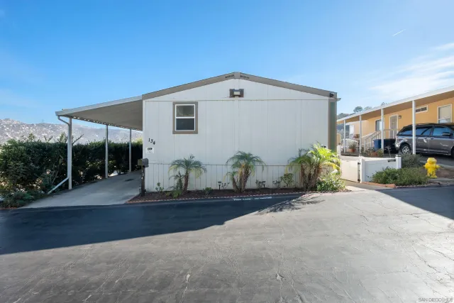 a view of a house with backyard and sitting area