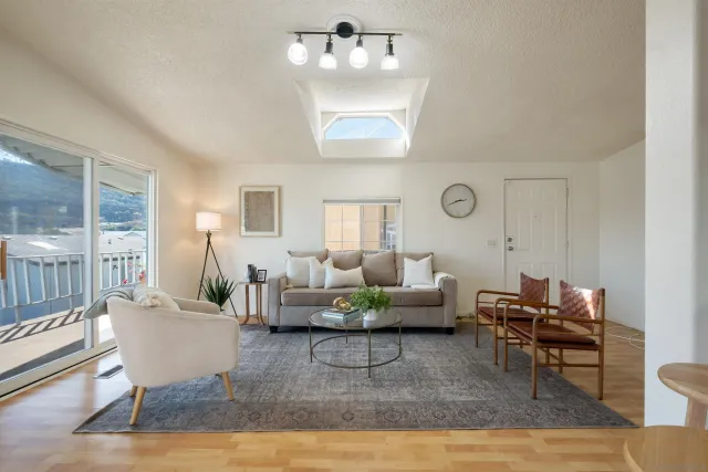 a living room with furniture rug and window