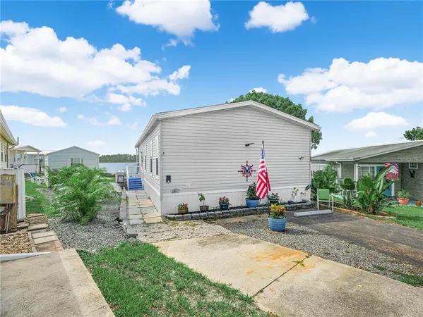 a view of multiple house with backyard and garden