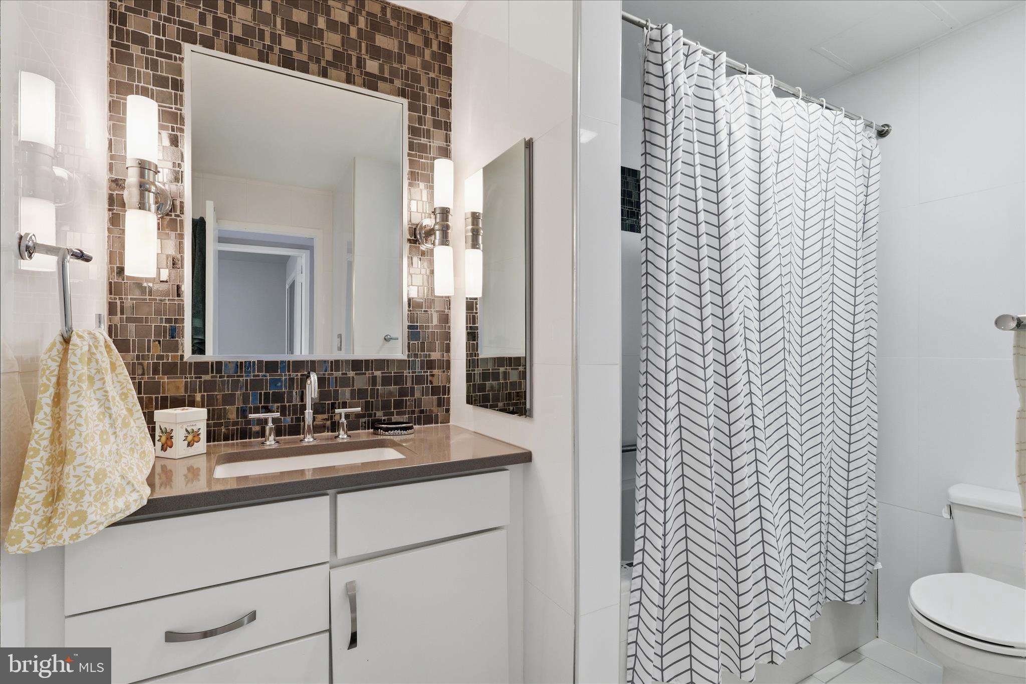 1661 Parkcrest Circle, Unit 5A/300 Reston, VA 20190 - Photo 12 of 22 a bathroom with a sink and a mirror