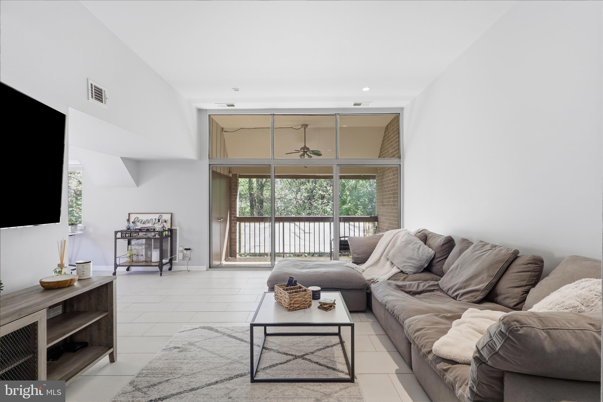 1661 Parkcrest Circle, Unit 5A/300 Reston, VA 20190 - Photo 4 of 22 a living room with furniture and a flat screen tv