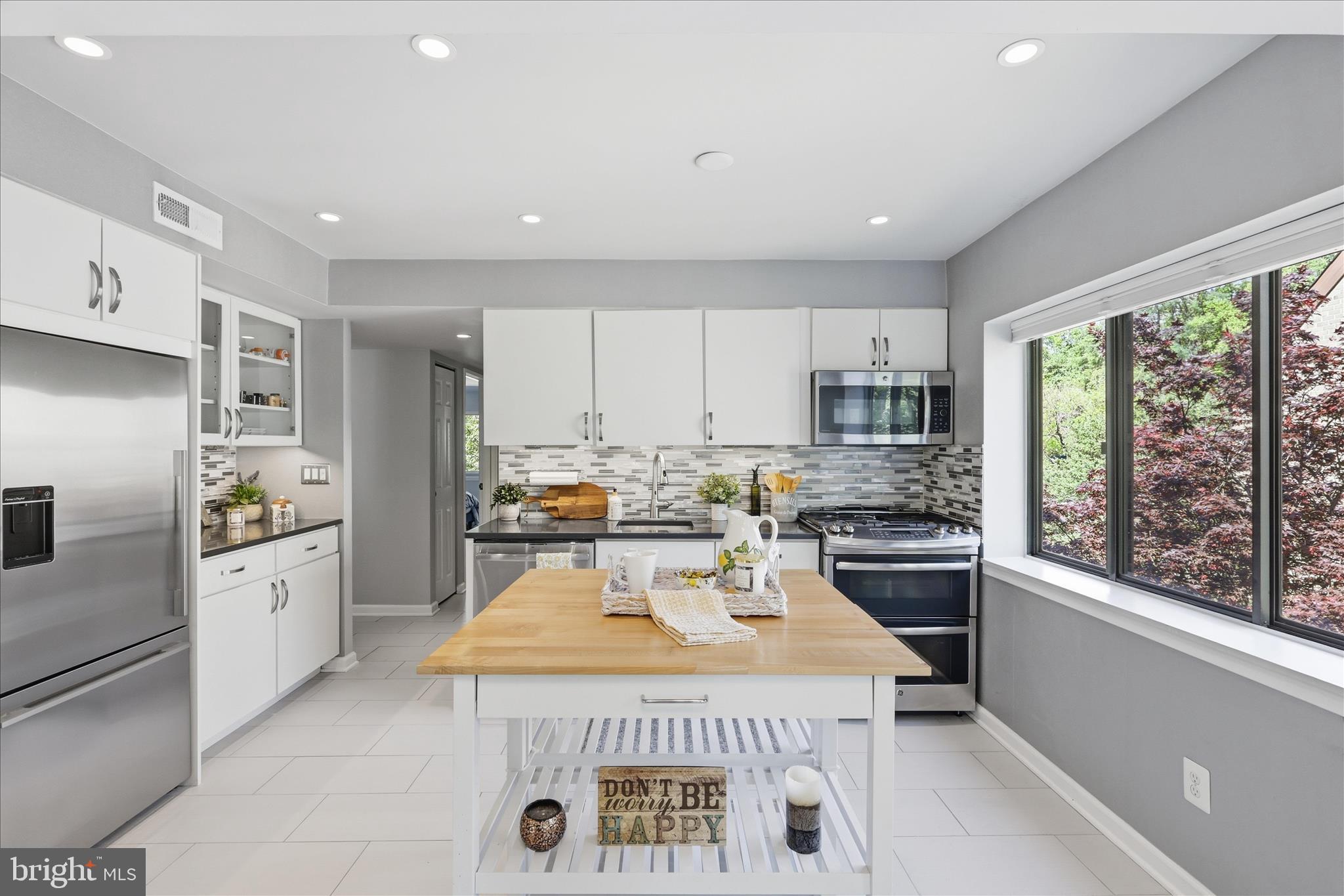 1661 Parkcrest Circle, Unit 5A/300 Reston, VA 20190 - Photo 7 of 22 a kitchen with a stove a refrigerator a sink dishwasher and white cabinets with wooden floor