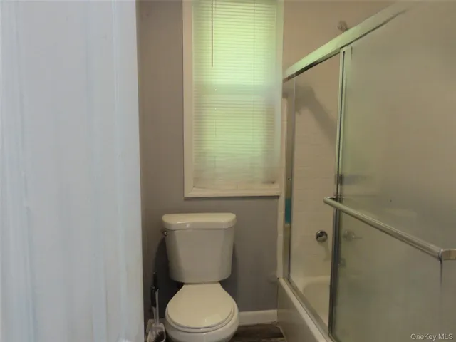 a white toilet sitting next to a bathroom sink