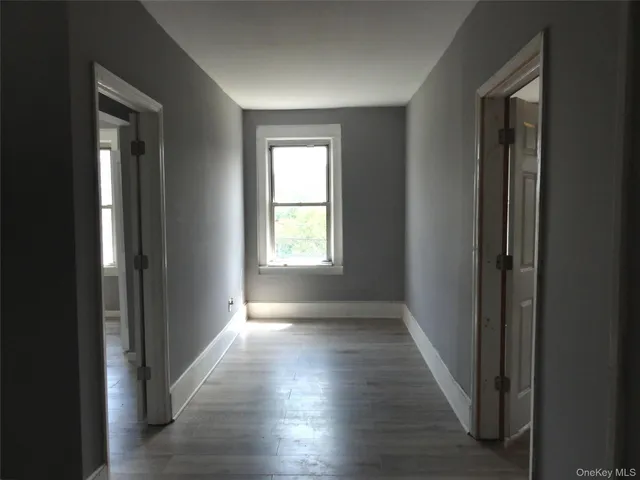 a view of hallway with wooden floor
