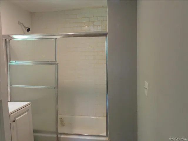 a bathroom with a glass shower door