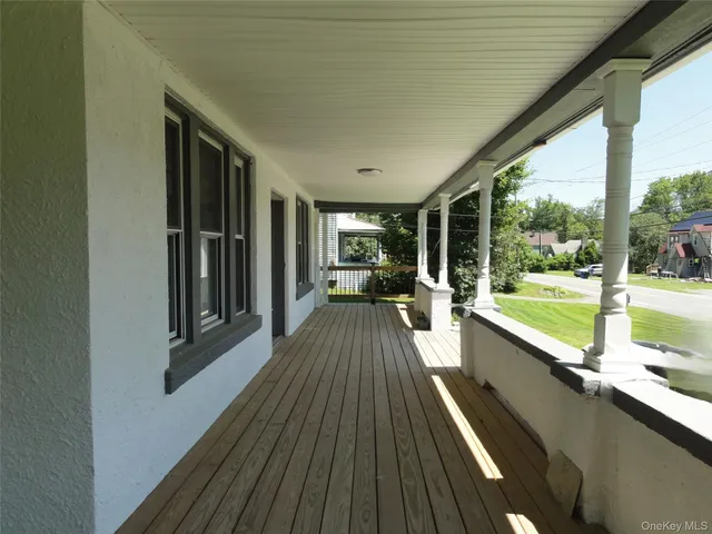 a view of balcony with a large window and wooden floor