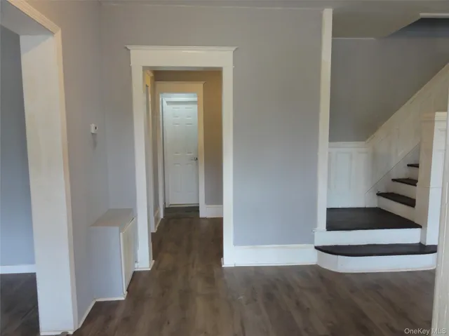 a view of a hallway view with wooden floor and staircase
