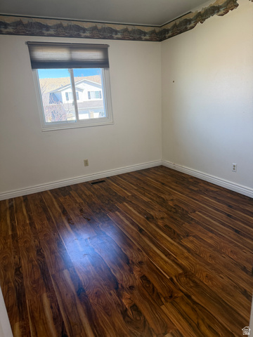 1259 West Raintree Drive Price, UT 84501 - Photo 4 of 10 Empty room with dark wood-style floors