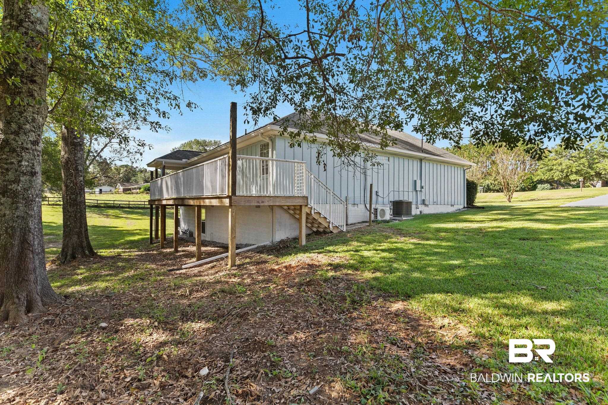 35650 Spring Road North Stapleton, AL 36578 - Photo 60 of 70 View of side of home featuring a yard, a wooden deck, stairs, and hardie siding
