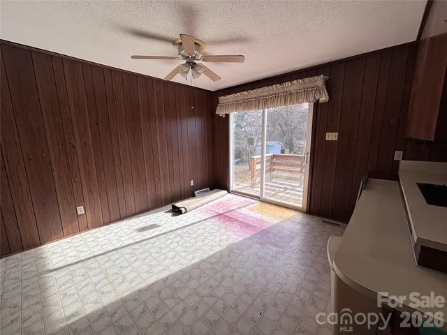 a view of a hallway with windows and chandelier