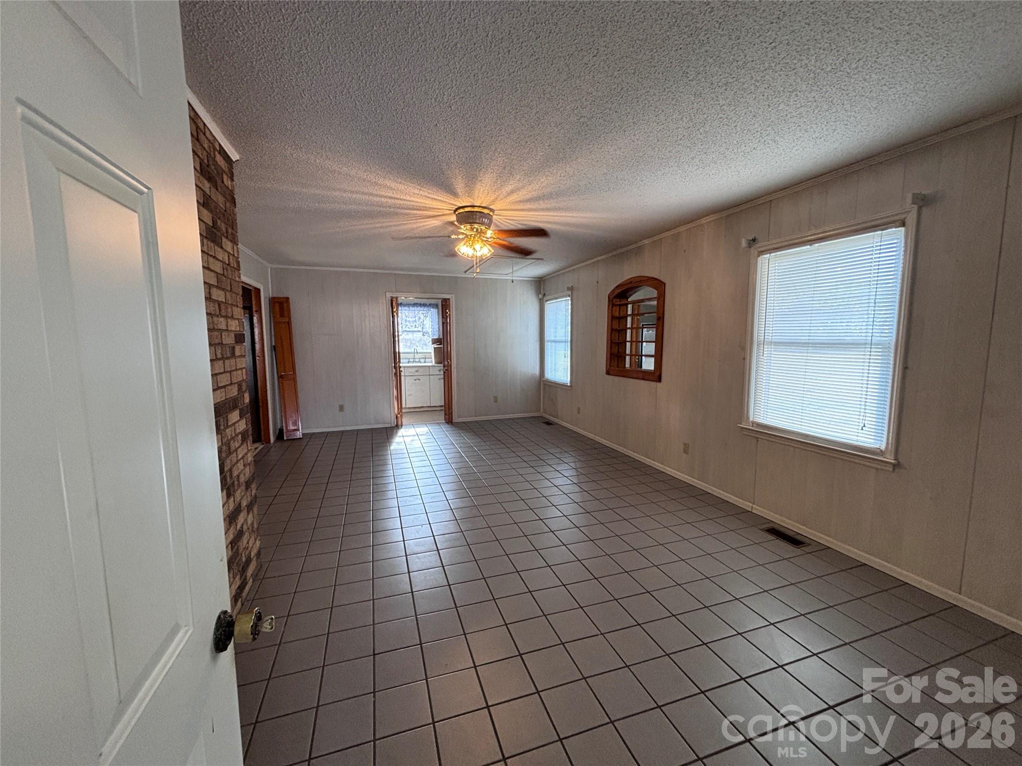 14740 Hatley-Burris Road Oakboro, NC 28129 - Photo 12 of 24 a view of a hallway with windows and chandelier