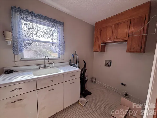 a kitchen with a refrigerator and a sink