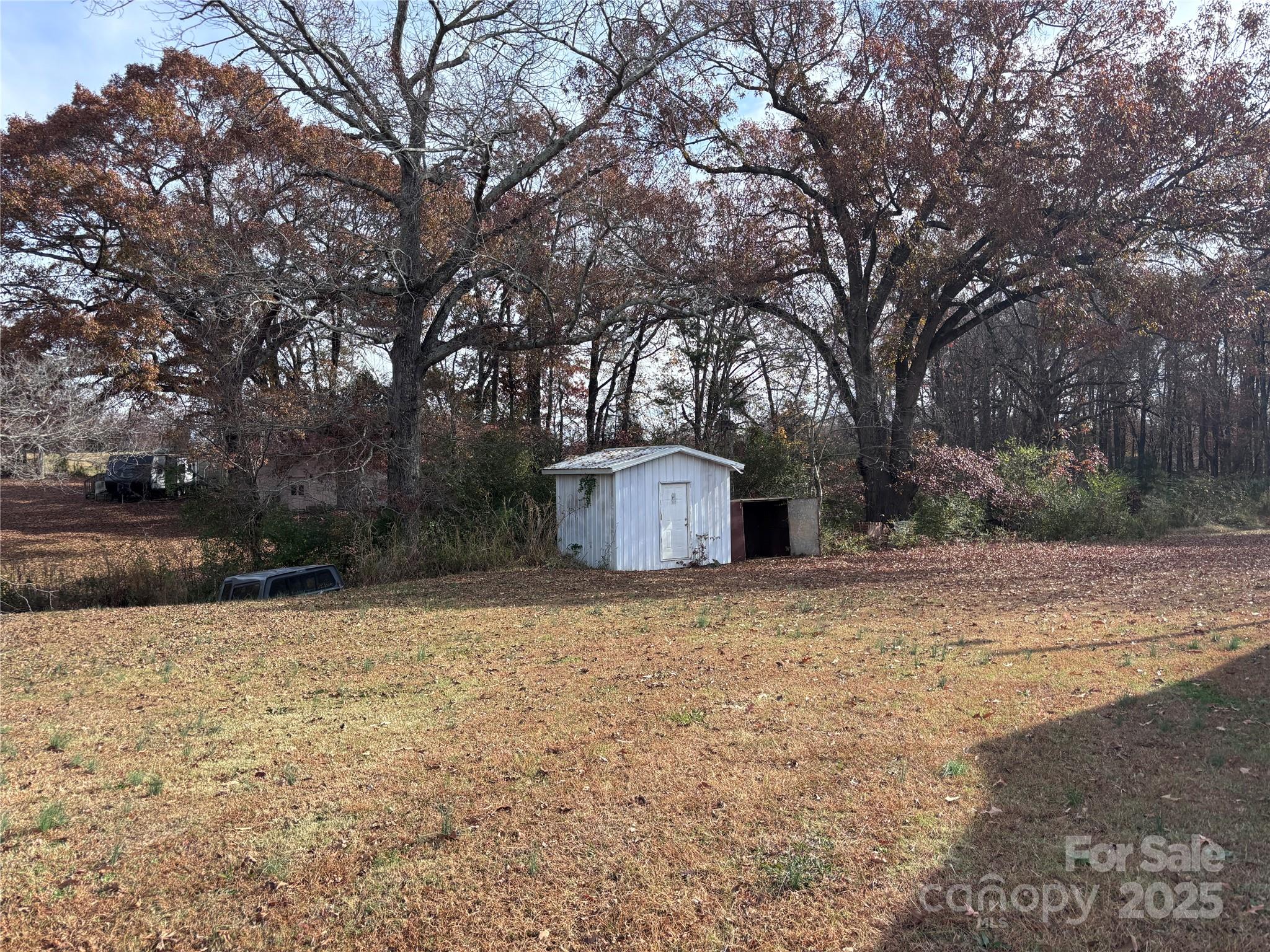 14740 Hatley-Burris Road Oakboro, NC 28129 - Photo 22 of 26 a house with trees in front of it