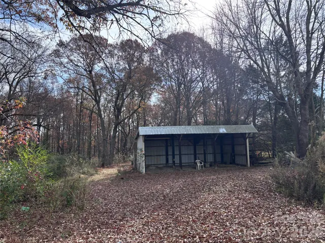 a view of a house with a yard covered in snow