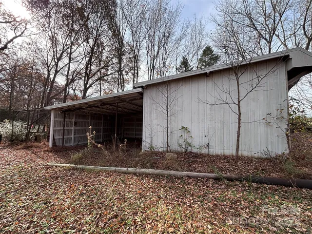a view of a house with a yard covered in snow