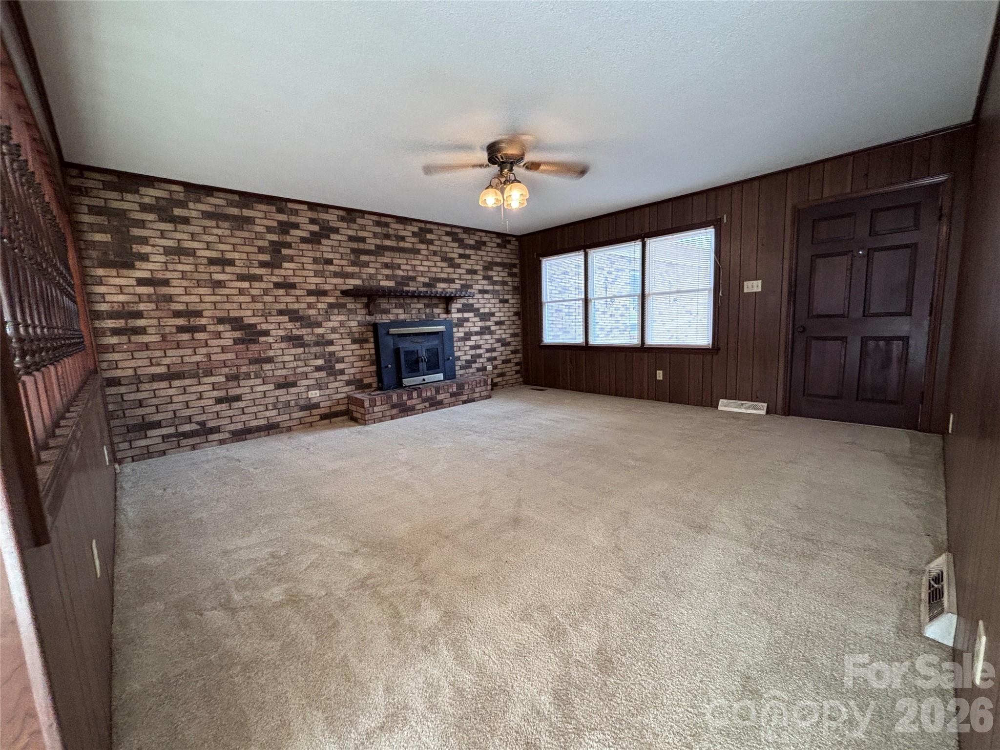 14740 Hatley-Burris Road Oakboro, NC 28129 - Photo 7 of 24 a view of a livingroom with a fireplace and window
