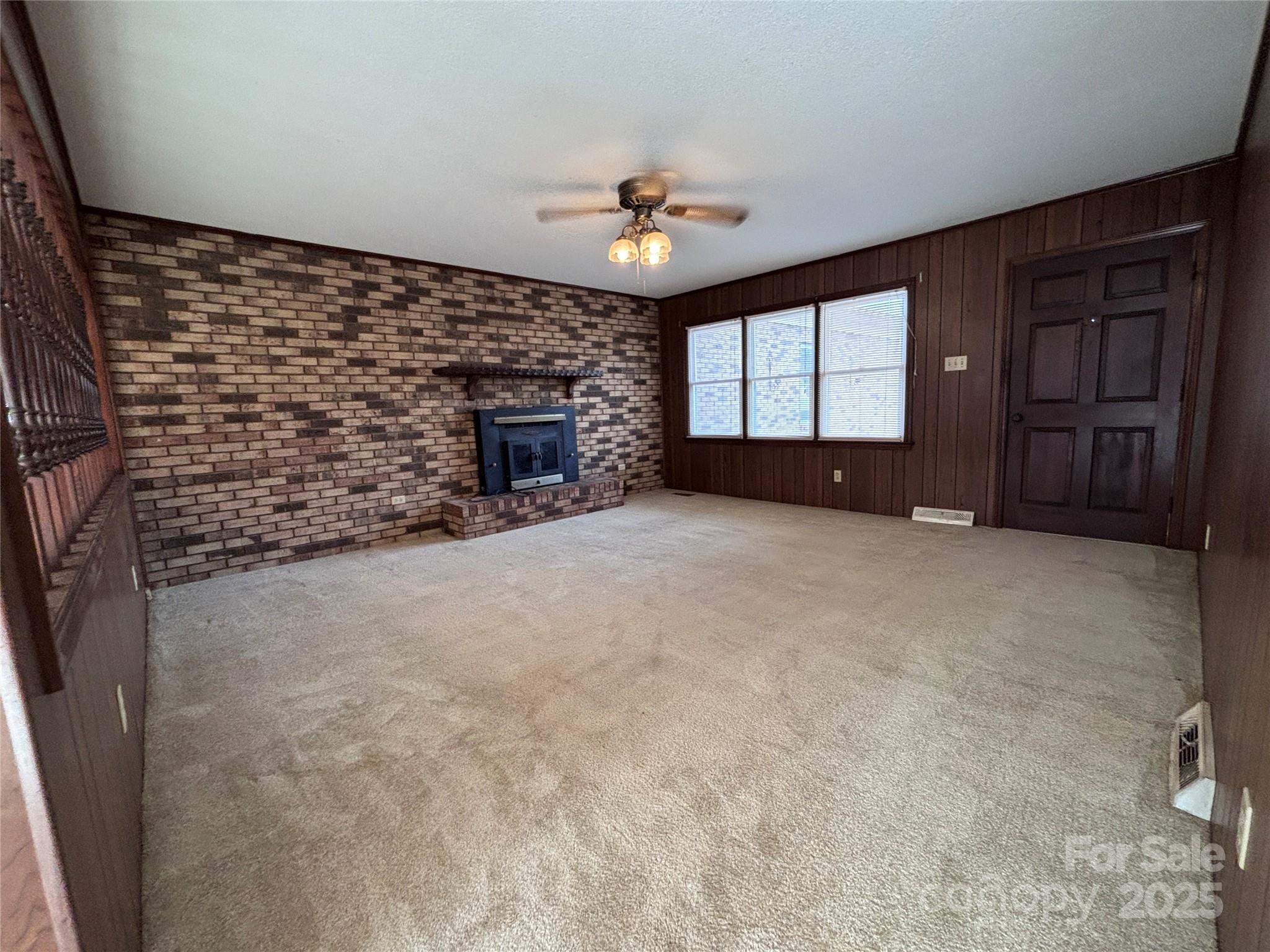 14740 Hatley-Burris Road Oakboro, NC 28129 - Photo 9 of 26 a view of a livingroom with a fireplace and window