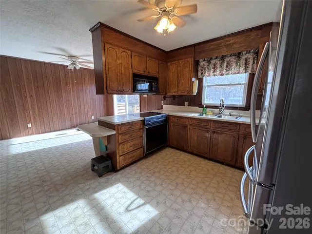 a kitchen with refrigerator and window