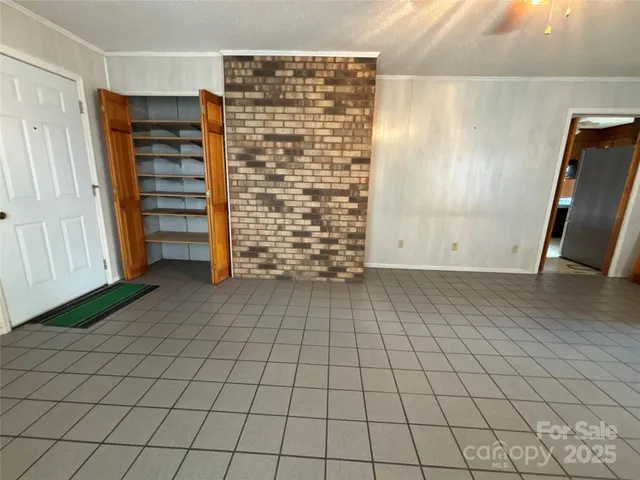 a view of a hallway with windows and chandelier