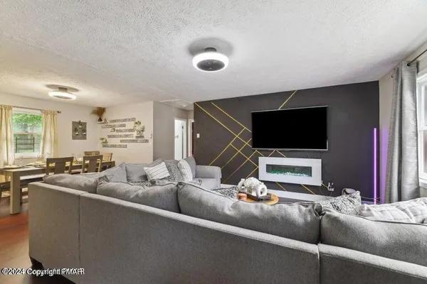 a living room with furniture and a flat screen tv