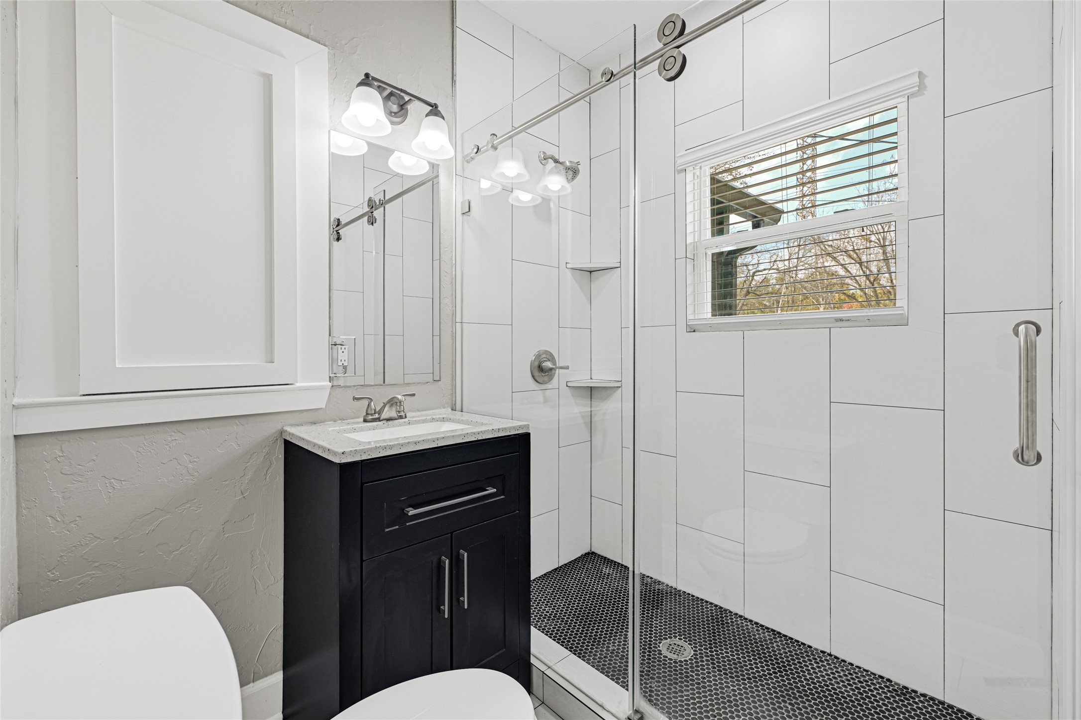 7403 Cayton Street Houston, TX 77061 - Photo 11 of 18 a bathroom with a sink a toilet a mirror and vanity
