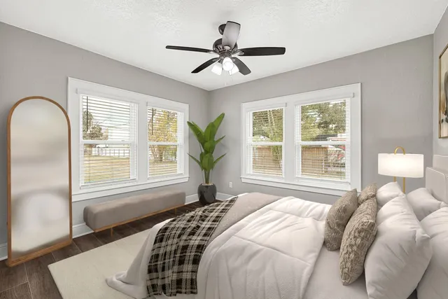 a bedroom with a large bed and a window