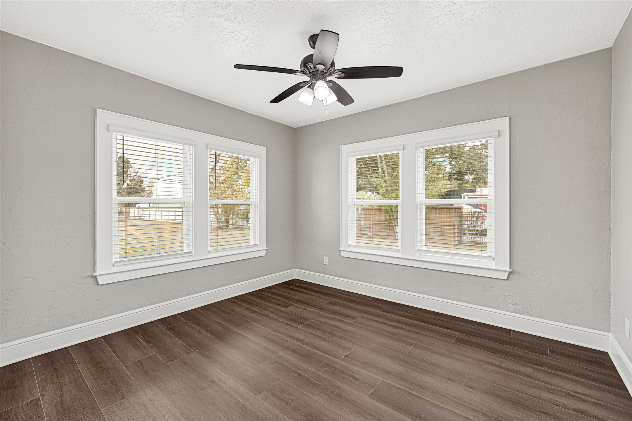 7403 Cayton Street Houston, TX 77061 - Photo 13 of 18 a view of an empty room with wooden floor and a window