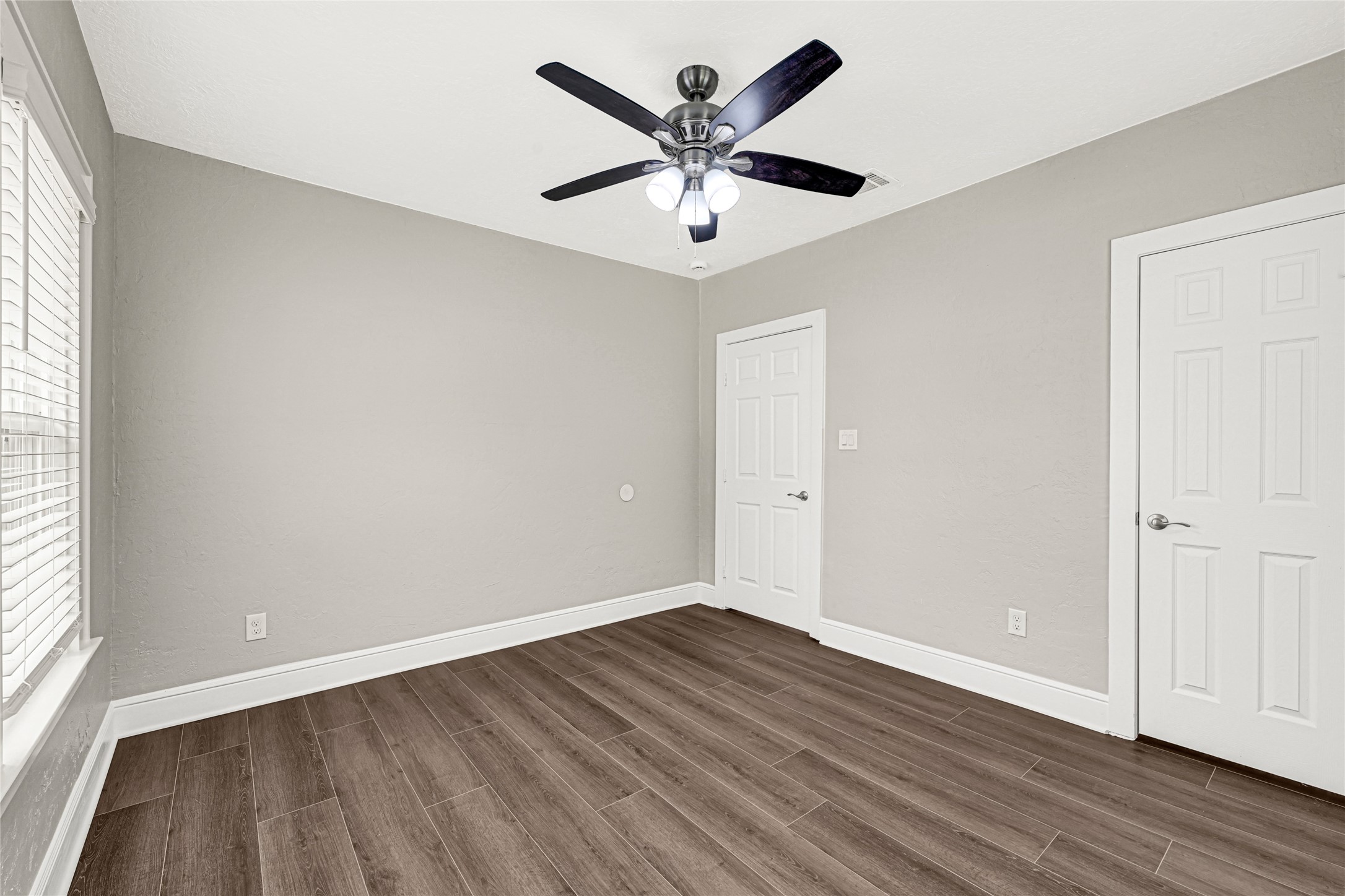 7403 Cayton Street Houston, TX 77061 - Photo 14 of 18 an empty room with wooden floor and windows
