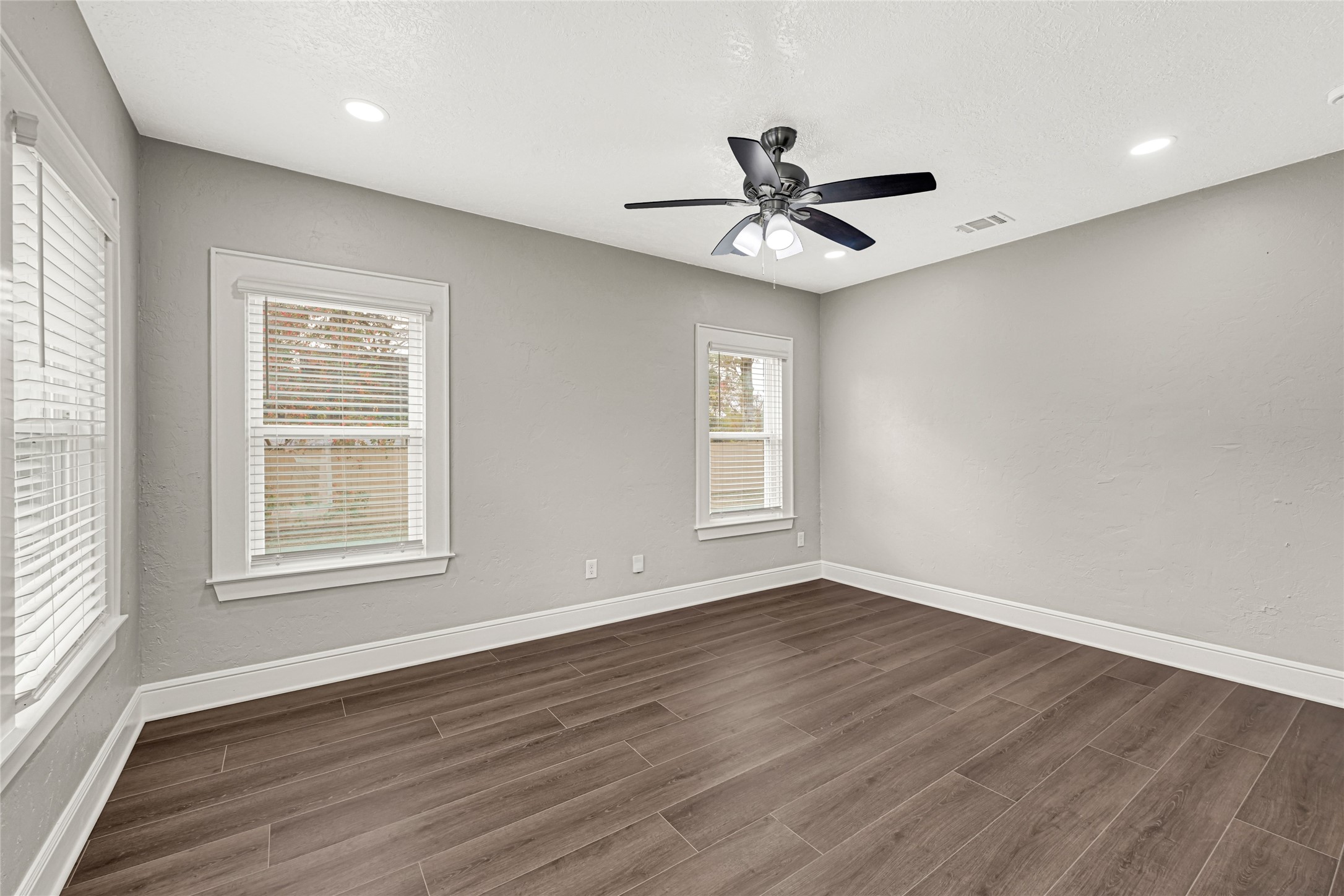 7403 Cayton Street Houston, TX 77061 - Photo 3 of 18 a view of an empty room with wooden floor and a window