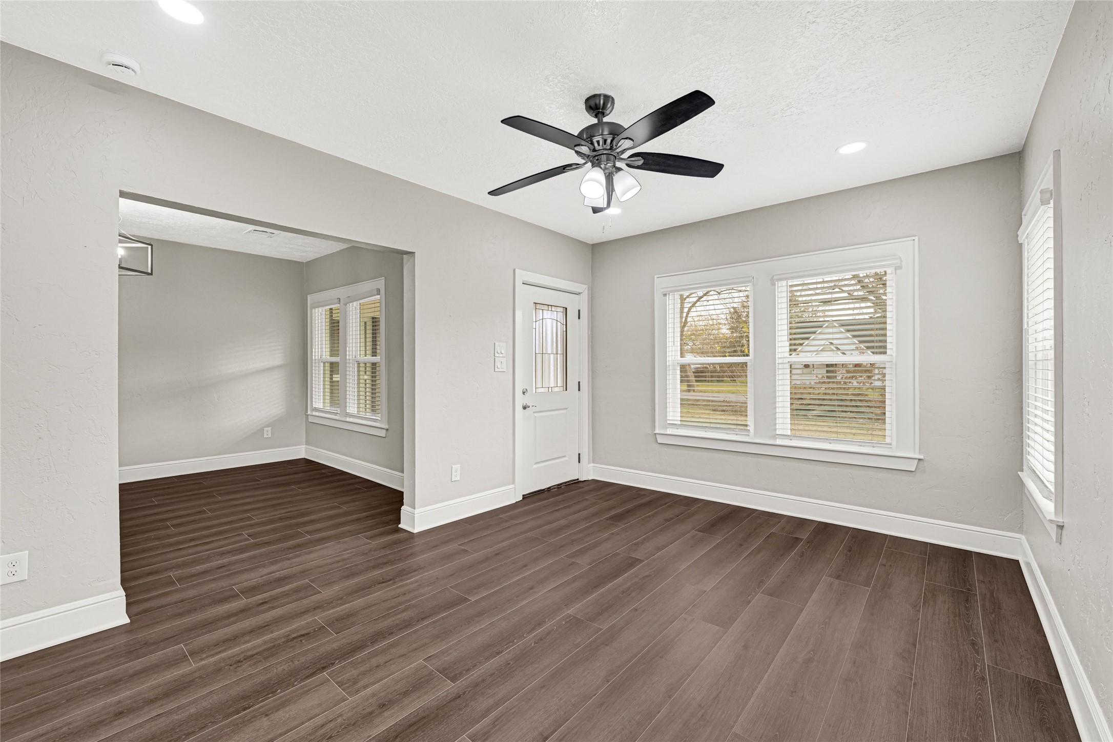 7403 Cayton Street Houston, TX 77061 - Photo 5 of 18 a view of an empty room with wooden floor and a window