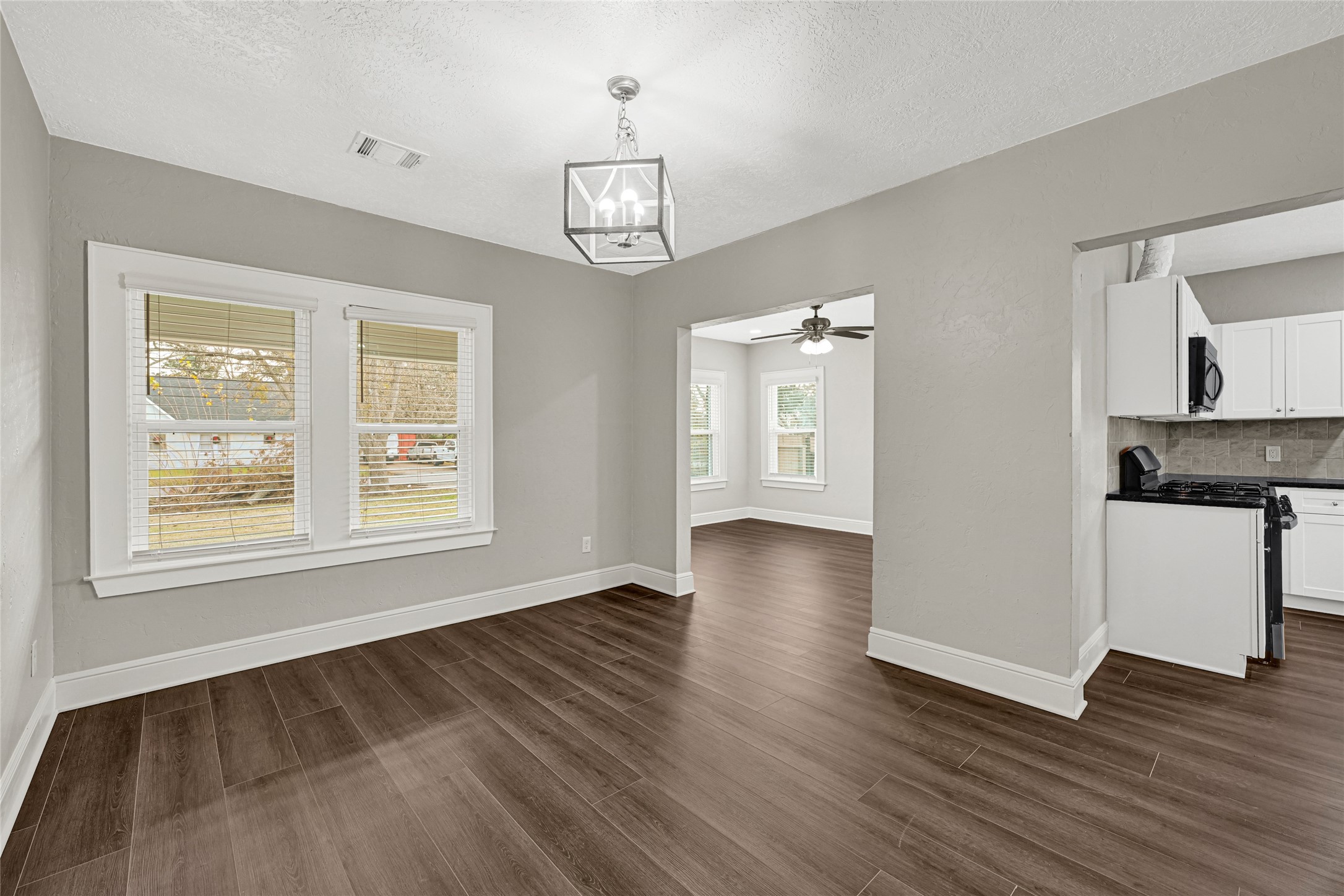 7403 Cayton Street Houston, TX 77061 - Photo 7 of 18 a view of an empty room with a window and wooden floor