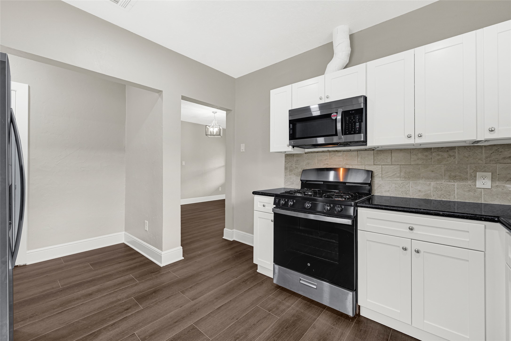 7403 Cayton Street Houston, TX 77061 - Photo 10 of 18 a kitchen with white cabinets and stainless steel appliances