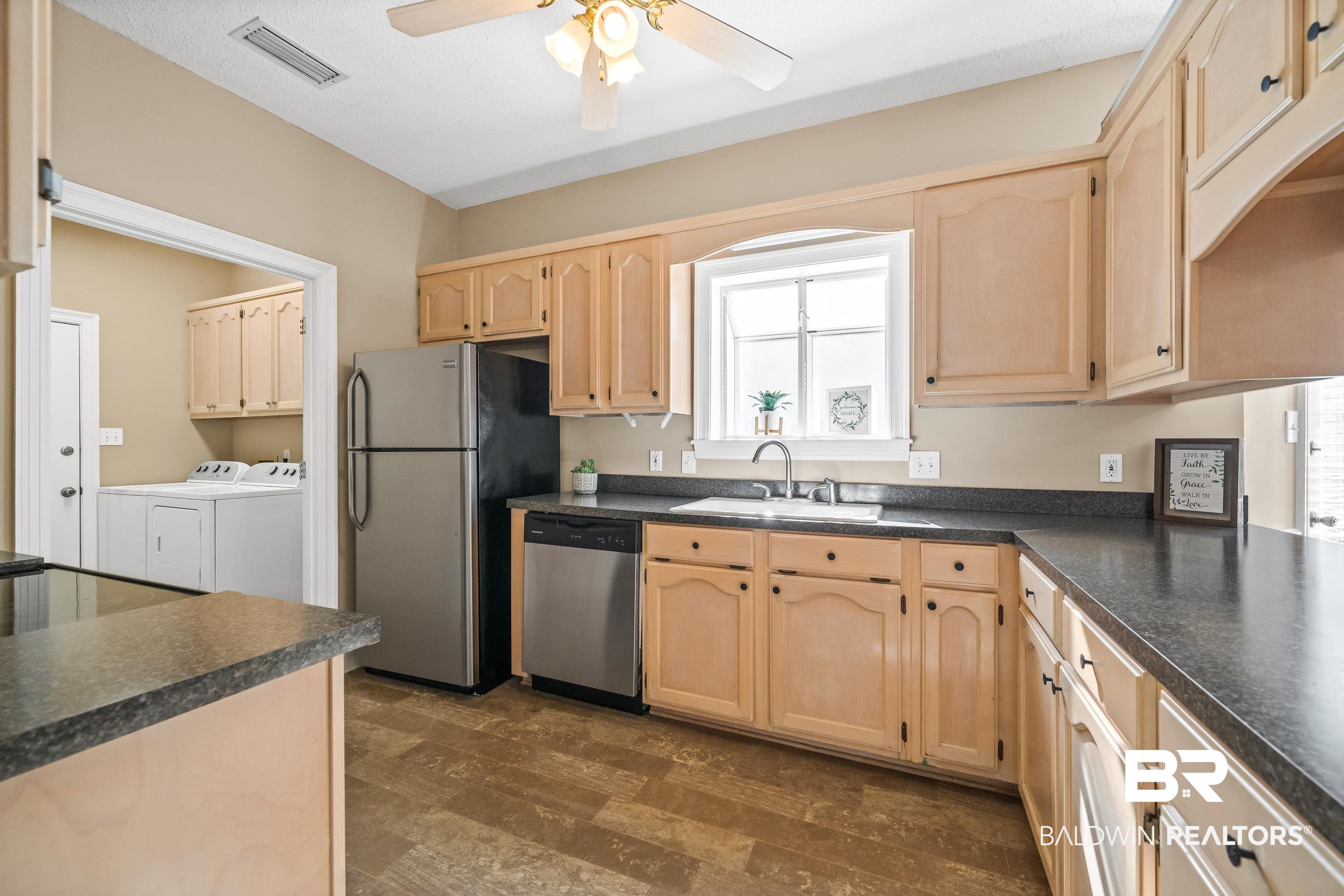 27 Cottage Drive Fairhope, AL 36532 - Photo 11 of 33 Kitchen featuring light brown cabinets, dark countertops, and stainless steel appliances