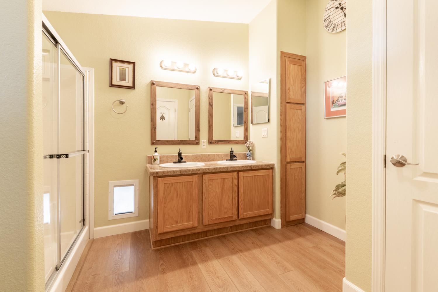 1273 South Rice Road, Unit 12 Ojai, CA 93023 - Photo 15 of 27 a bathroom with a double vanity sink a mirror and a shower
