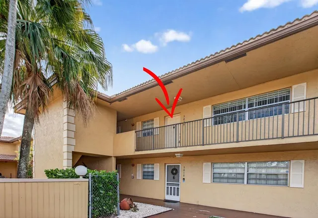 a view of a house with a palm tree