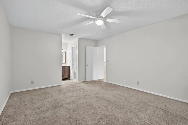 an empty room with a ceiling fan and a ceiling fan