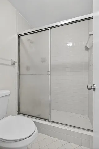 a bathroom that has a glass shower door