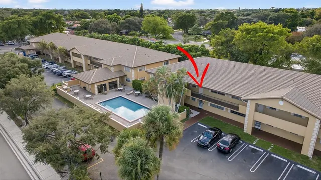 an aerial view of a house with a garden and trees