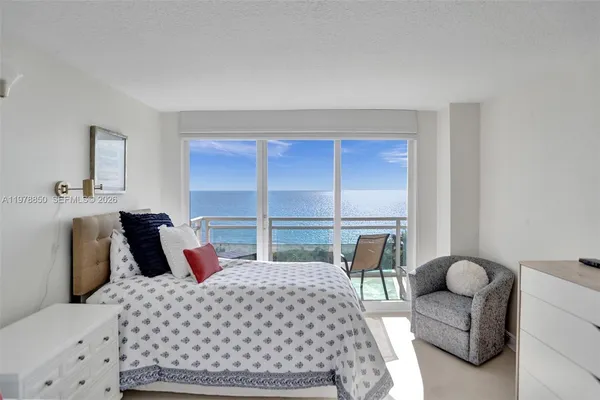 a bedroom with a large bed and a large window