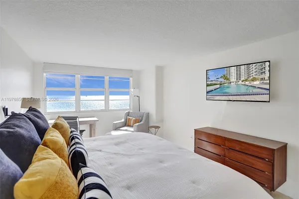 a bedroom with a bed and glass windows