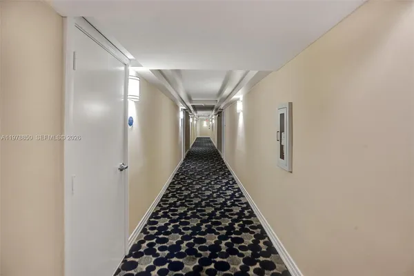 a view of a hallway with wooden floor and stairs