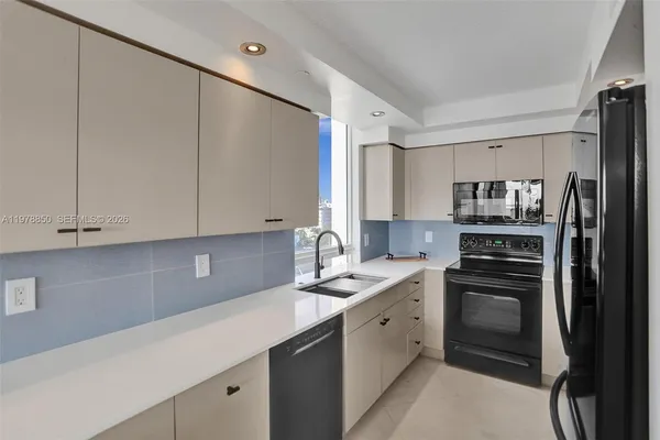 a kitchen with a sink cabinets and stainless steel appliances