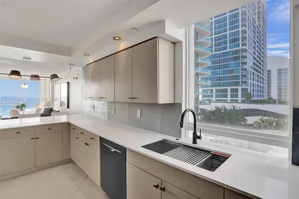 a kitchen with a sink cabinets and window