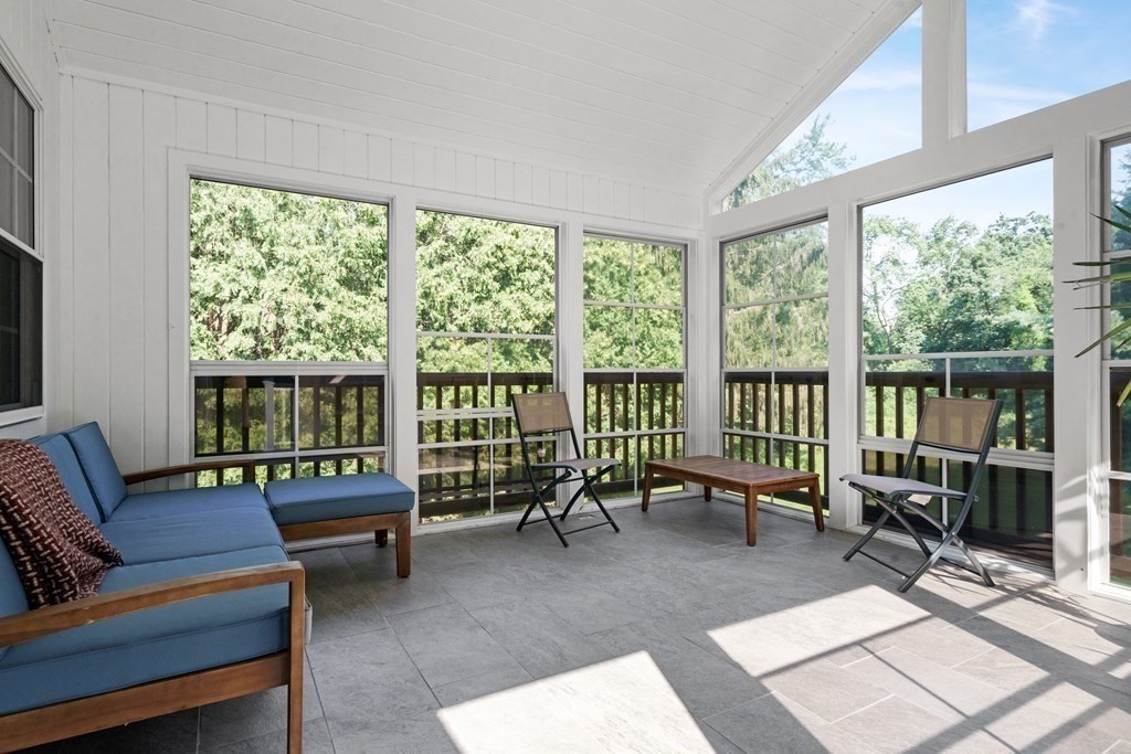 36 Putnam Road Bedford, MA 01730 - Photo 14 of 15 a living room with furniture and a floor to ceiling window