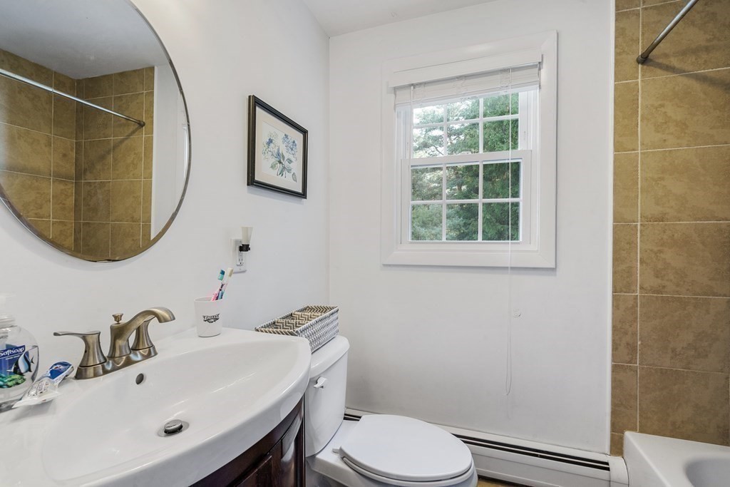 36 Putnam Road Bedford, MA 01730 - Photo 10 of 15 a bathroom with a sink mirror and toilet