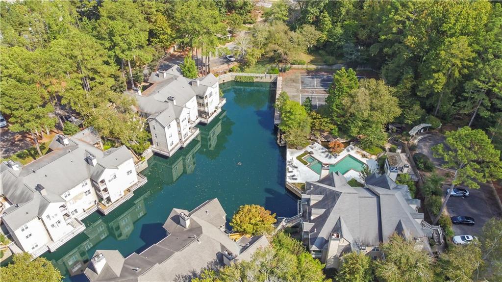 an aerial view of a house with a yard basket ball court and outdoor seating