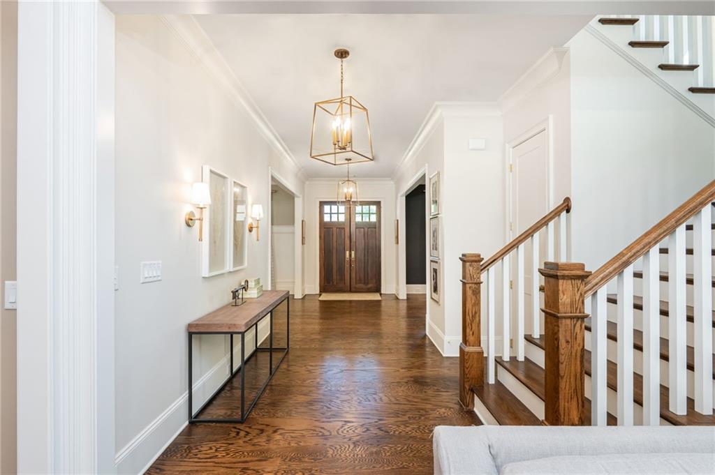 4184 Thompson Mill Road Buford, GA 30519 - Photo 13 of 53 a hallway with wooden floor and staircase