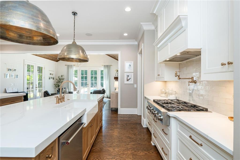 4184 Thompson Mill Road Buford, GA 30519 - Photo 22 of 53 a kitchen with a stove and a wooden floor