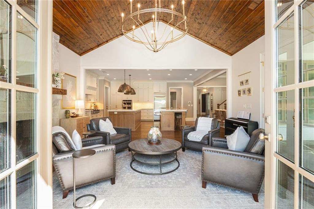 4184 Thompson Mill Road Buford, GA 30519 - Photo 26 of 53 a living room with furniture and a chandelier